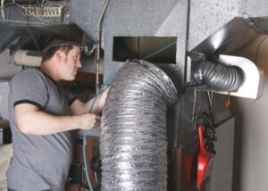 furnace-technician-inspecting-unit